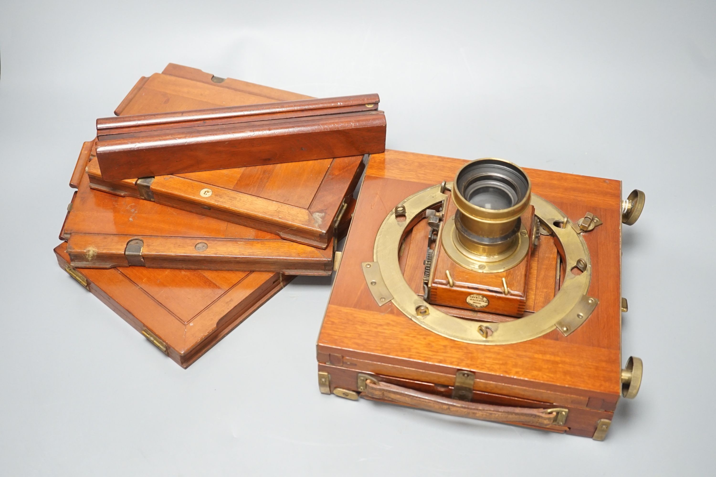 A Thornton Pickard mahogany and brass plate camera, three plates and a stand, 20cm sq.